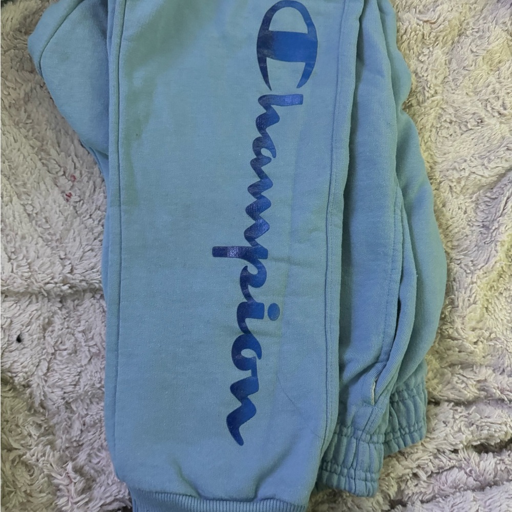 Large Baby Blue champion sweatpants with dark blue lettering and symbol
